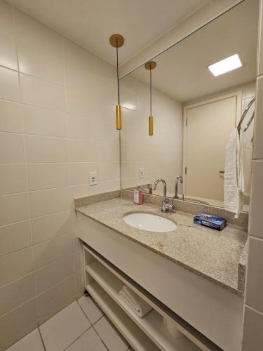 a bathroom with a sink and a mirror at Excelente Flat Duplex com vaga de garagem no Fusion Hotel in Brasília