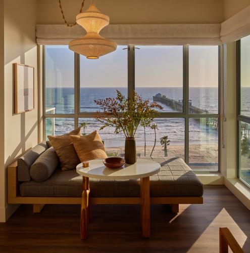 a living room with a couch and a table at Mission Pacific Beach Resort, part of JdV by Hyatt in Oceanside