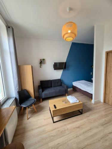 a living room with a couch and a coffee table at Appartement à thermal in Nancy
