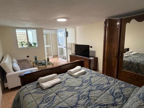 a bedroom with a bed with two towels on it at Arma central Garden in Arma di Taggia