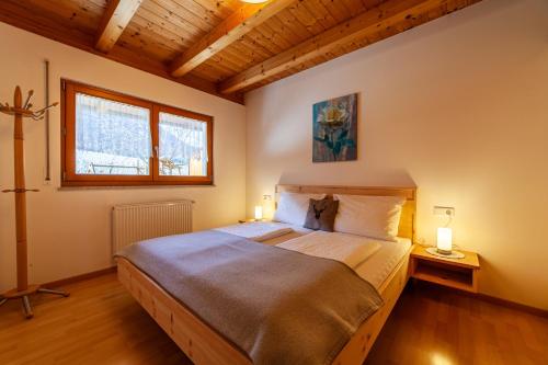 a bedroom with a large bed with two lamps at Heiligenhof in Laces