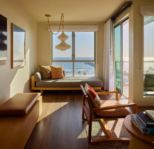 a living room with a couch and a view of the ocean at Mission Pacific Beach Resort, part of JdV by Hyatt in Oceanside