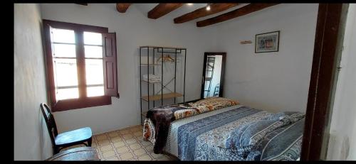 a bedroom with a bed and a window at Can Manuel in Gabet