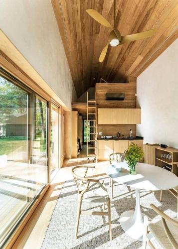 a dining room with a table and a ceiling fan at Architectural Cabin 18 mins to Catamount in Taghkanic