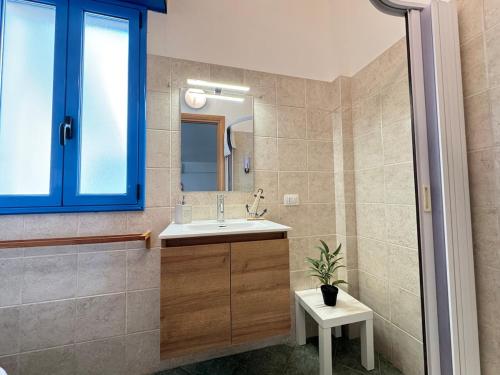 a bathroom with a sink and a mirror at Casa Azul - Social Apartment - parcheggio, clima, 200mt dal mare in Scoglitti
