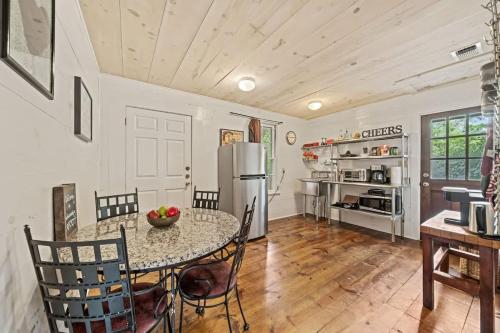 a kitchen with a table and chairs and a refrigerator at Suite Elliana w/Hot Tub & Outdoor Fireplace! in Fredericksburg
