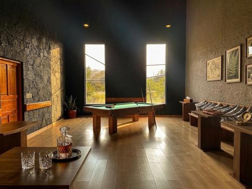 a room with a pool table in the middle of it at Orgánico Hotel Boutique TEPOZTLÁN in Tepoztlán