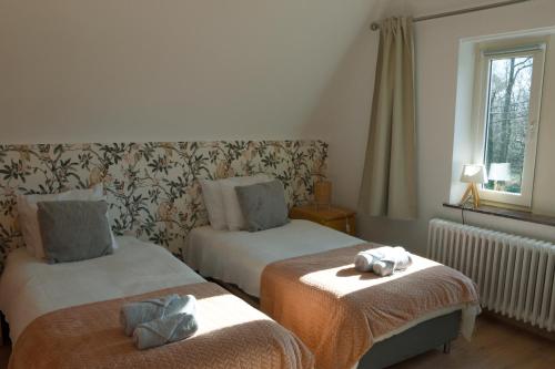 a bedroom with two beds with stuffed animals on them at La maison du bienvenu in Namur