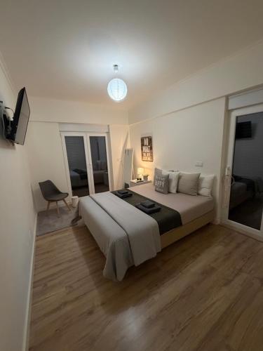 a bedroom with a large bed and a window at Feel Like Your Home in Montijo
