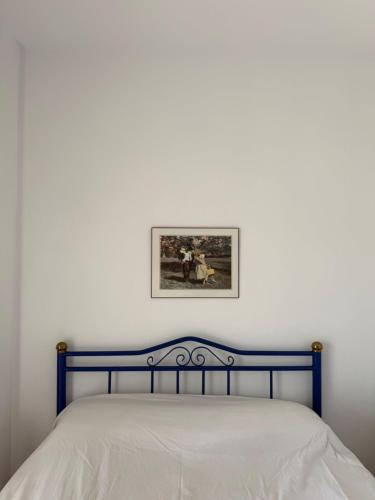 a bed in a bedroom with a picture on the wall at Kallithea Cove in Kallithea Halkidikis