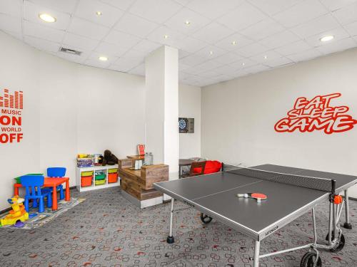 an office with a ping pong table in a room at Ibis Budapest Citysouth in Budapest