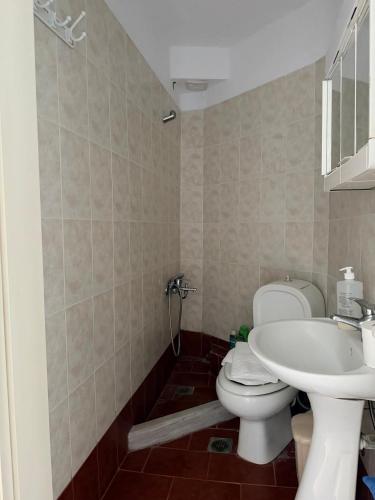 a bathroom with a toilet and a sink at Kallithea Cove in Kallithea Halkidikis