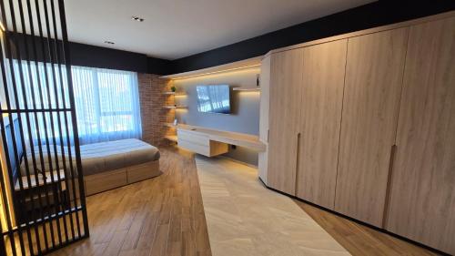 a bedroom with a bed and a television in a room at STREET MALL Luna N6-3 in Puebla