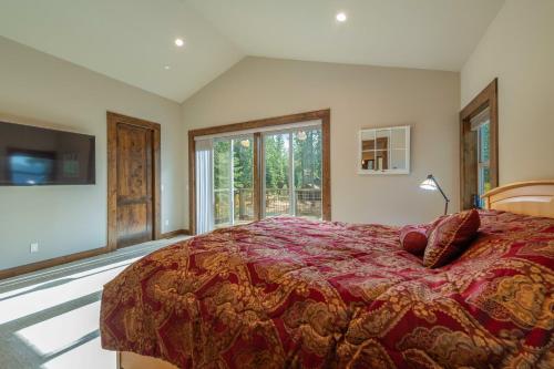 a bedroom with a large bed and a large window at 4BR Home w/ 2 Decks, Near Lake & Ski Resorts in Truckee
