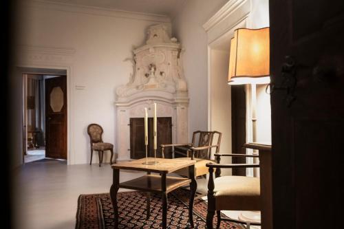 a living room with a table and a fireplace at Ansitz Thierburg Suites in Merano