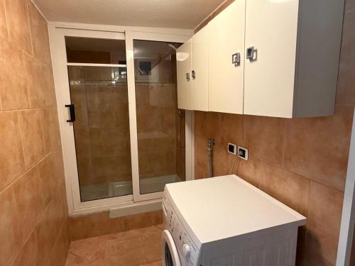 a laundry room with a washer and dryer in it at Arma central Garden in Arma di Taggia