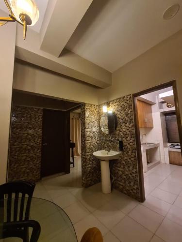 a living room with a sink and a kitchen at Couple room, attached balcony in Safipur