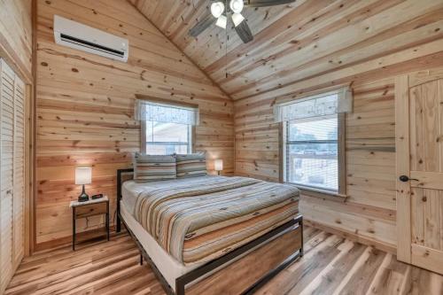 a bedroom with a bed in a log cabin at Rustic Cabin with Firepit and Grill - 10 mins to Main St in Rocky Hill