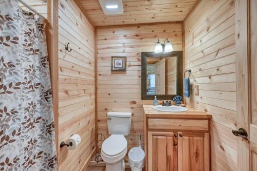 a wooden bathroom with a toilet and a sink at Rustic Cabin with Firepit and Grill - 10 mins to Main St in Rocky Hill