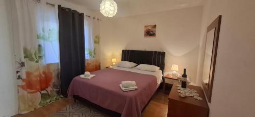 a bedroom with a bed with two towels on it at Bellevue in Podstrana