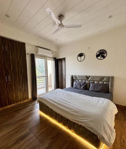 a bedroom with a bed with a light on it at The Huddle - Dusk in Dehradun