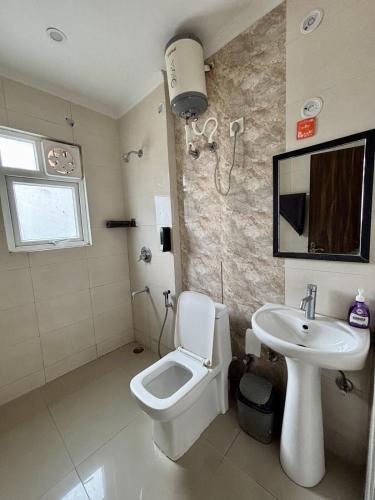 a bathroom with a toilet and a sink at The Huddle - Dusk in Dehradun