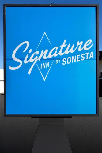 a computer screen with a blue sign that reads adventure inn by someone at Signature Inn Medford Downtown - Newly Renovated in Medford