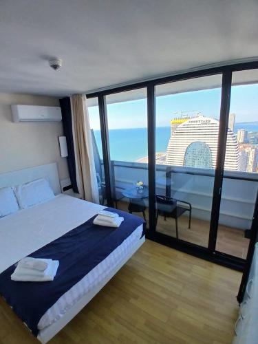 a bedroom with a bed and a view of a building at best VIP HOTEL panorama suites IN batumi R in Batumi