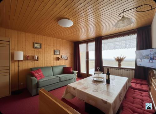 a living room with a couch and a table at Soldanella Cervinia apartment Vda Vacanze in Vetta CIR 0253 in Breuil-Cervinia