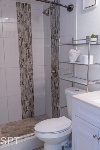 a bathroom with a toilet and a shower at Gulfview II #410 Luxe in South Padre Island