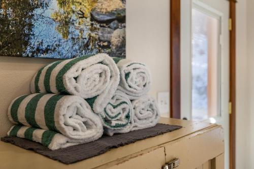 a pile of towels sitting on top of a dresser at Grizzly Bear Creek- Mt Rushmore Views- Hot tub in Keystone