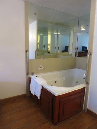 a bathroom with a large tub with a large mirror at Country Inn Ontario in Ontario