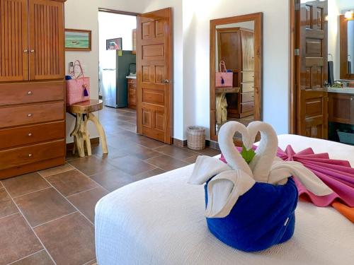 two swans in a blue bag on a bed at Casa Catalina - Tropical Escape in Puerto Morelos