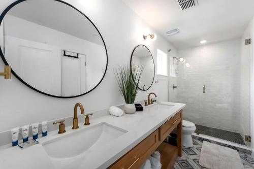 a bathroom with a tub and a large mirror at Rosé Retreat: Luxurious Getaway for 6, Hot Tub, Steps to Main Street in Fredericksburg