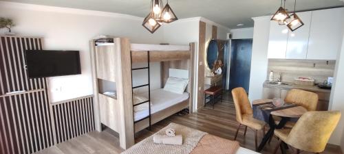 a small room with a bunk bed and a table at Pearl's apartments Old town Ohrid in Ohrid