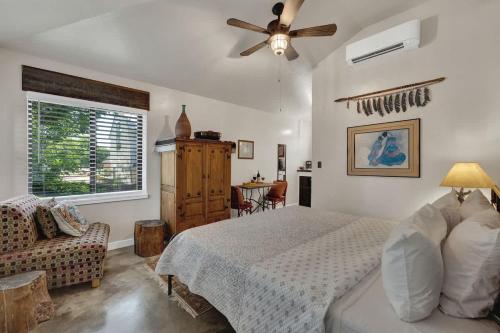 a bedroom with a bed and a ceiling fan at Rojo-Charming unit walking distance to Main St! in Fredericksburg