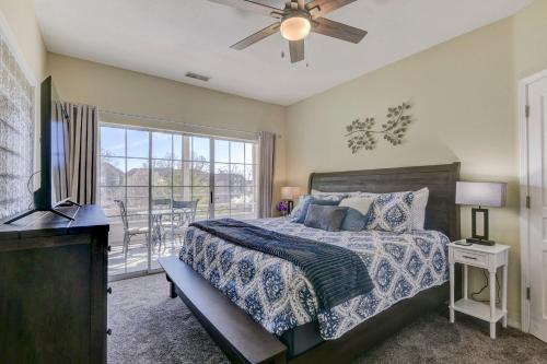a bedroom with a bed with a ceiling fan and a balcony at Amazing 2 bed 2 bath with Gorgeous View in Branson