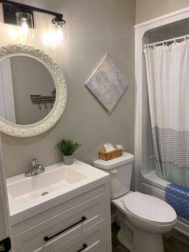 a bathroom with a sink and a toilet and a mirror at 8 Clarence Ln in Cavendish