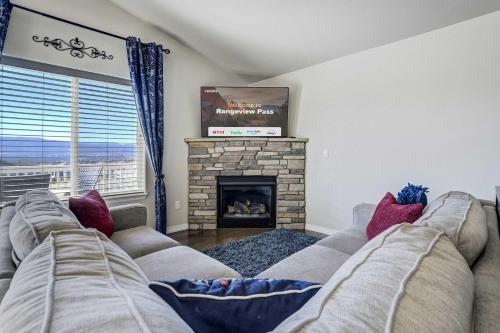 a living room with a couch and a fireplace at Rangeview Pass Pet Friendly with Epic Peak Views in Monument