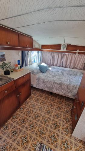 a bedroom with a bed in the middle of it at Raglan West Retro Beach Vibe Accommodation in Raglan