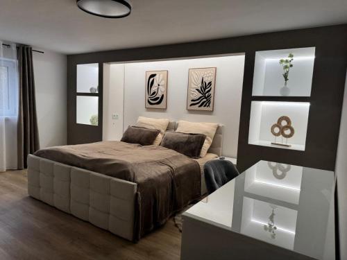 a bedroom with a bed and a table in it at Elfis Paradise in Wiesbaden