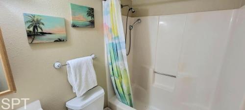 a bathroom with a shower and a toilet and a sink at Great Pool - Beach Access - Small Family Perfect in South Padre Island