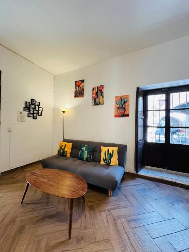 a living room with a couch and a coffee table at Casa Universidad in Guanajuato