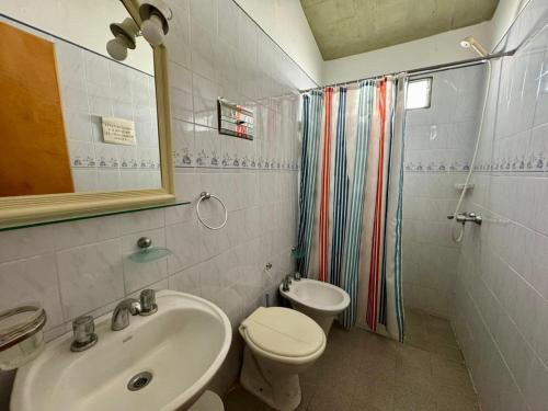 a bathroom with a sink and a toilet and a mirror at La Pantera in San Antonio de Arredondo