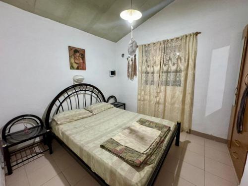 a bedroom with a bed and a window at La Pantera in San Antonio de Arredondo