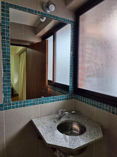 a bathroom with a sink and a mirror at Deptos Boutique in San Salvador de Jujuy