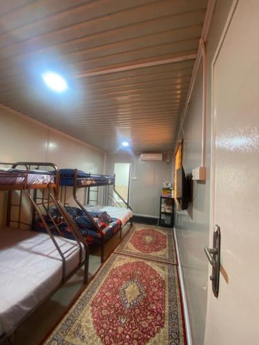 a room with two bunk beds and a rug at CTZ PAROH RIVER PARK in Jertih