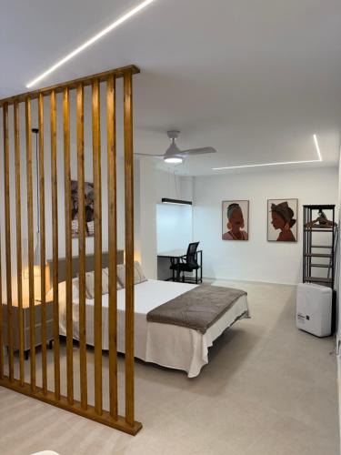 a bedroom with a bed and a table and chairs at Apartamentos San Antonio - GrupoAMI in Ontinyent