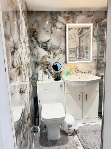 a bathroom with a toilet and a sink at Royal Noor Escape in Killingbeck