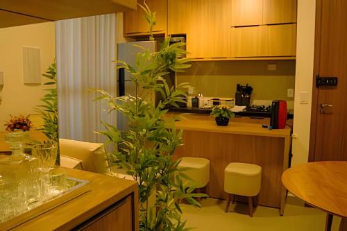 a kitchen with a table and some plants at Studios ZP in Uberlândia